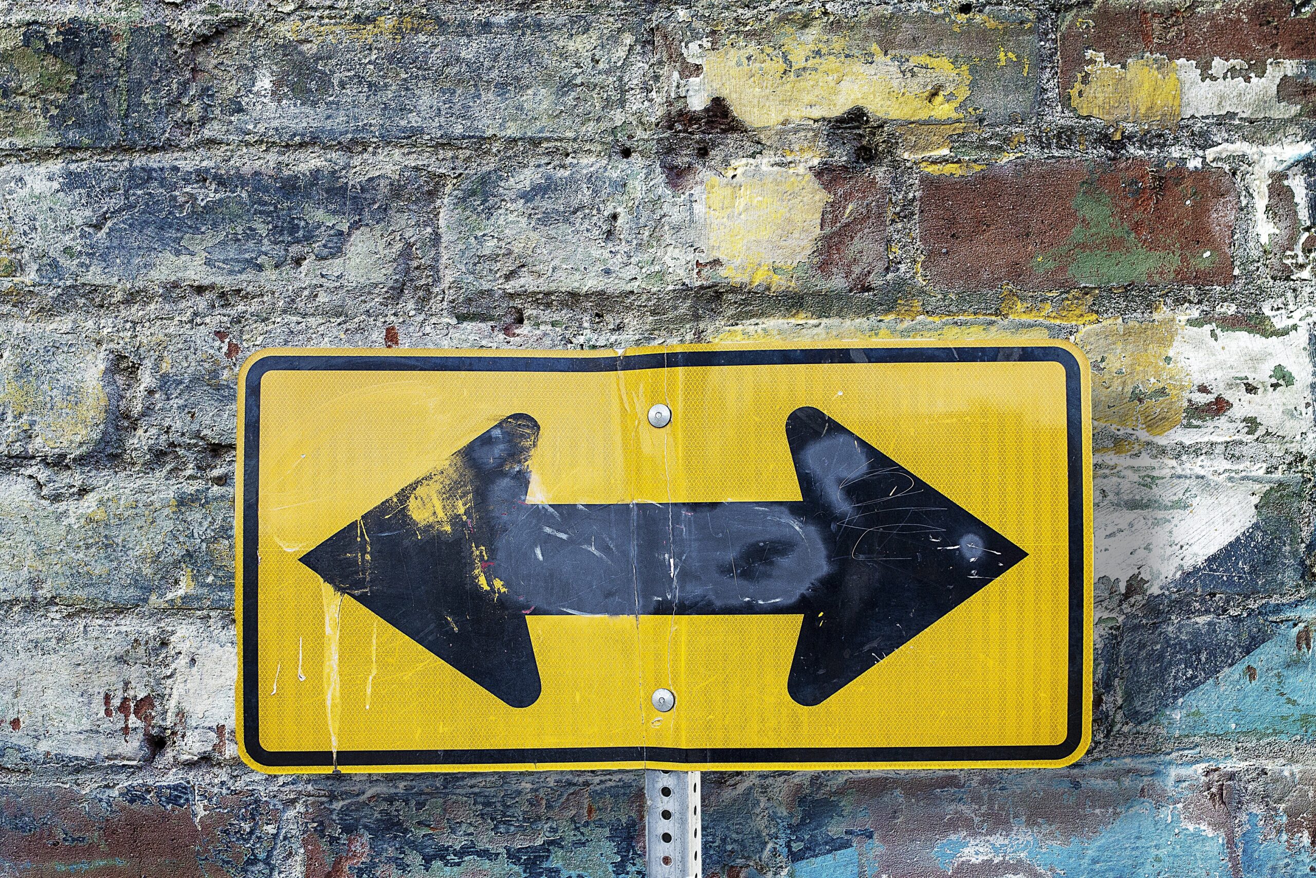 a street sign pointing left and right, outsource or hire
